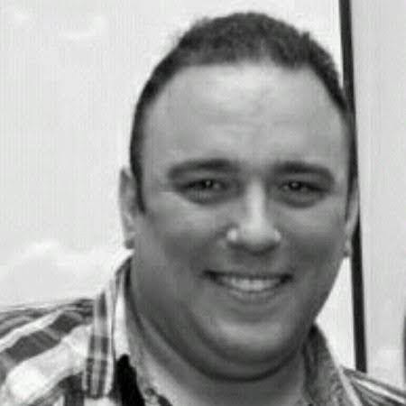 a man smiling at the camera