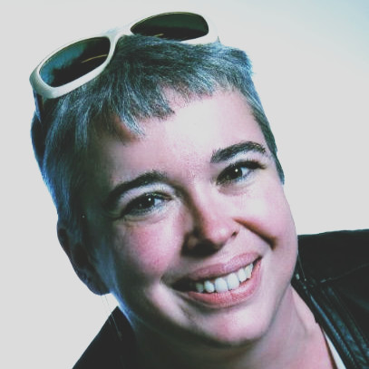 a woman smiling with sunglasses on her head