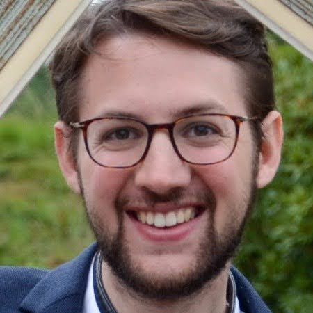 a man smiling at the camera