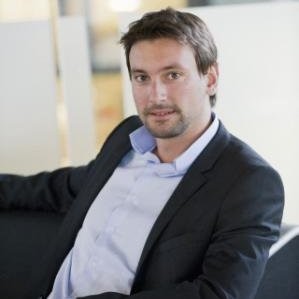 a man in a suit sitting on a chair
