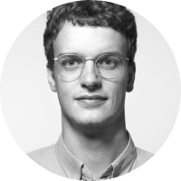 a man wearing glasses and smiling