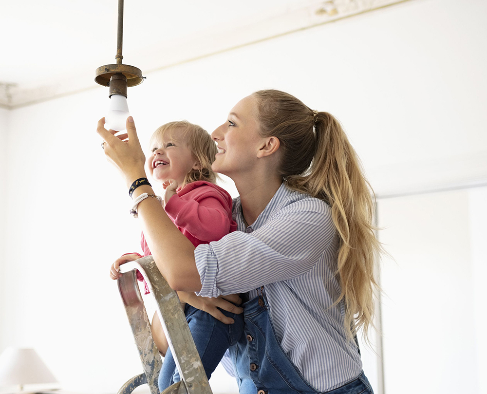 lady fixing light bulb