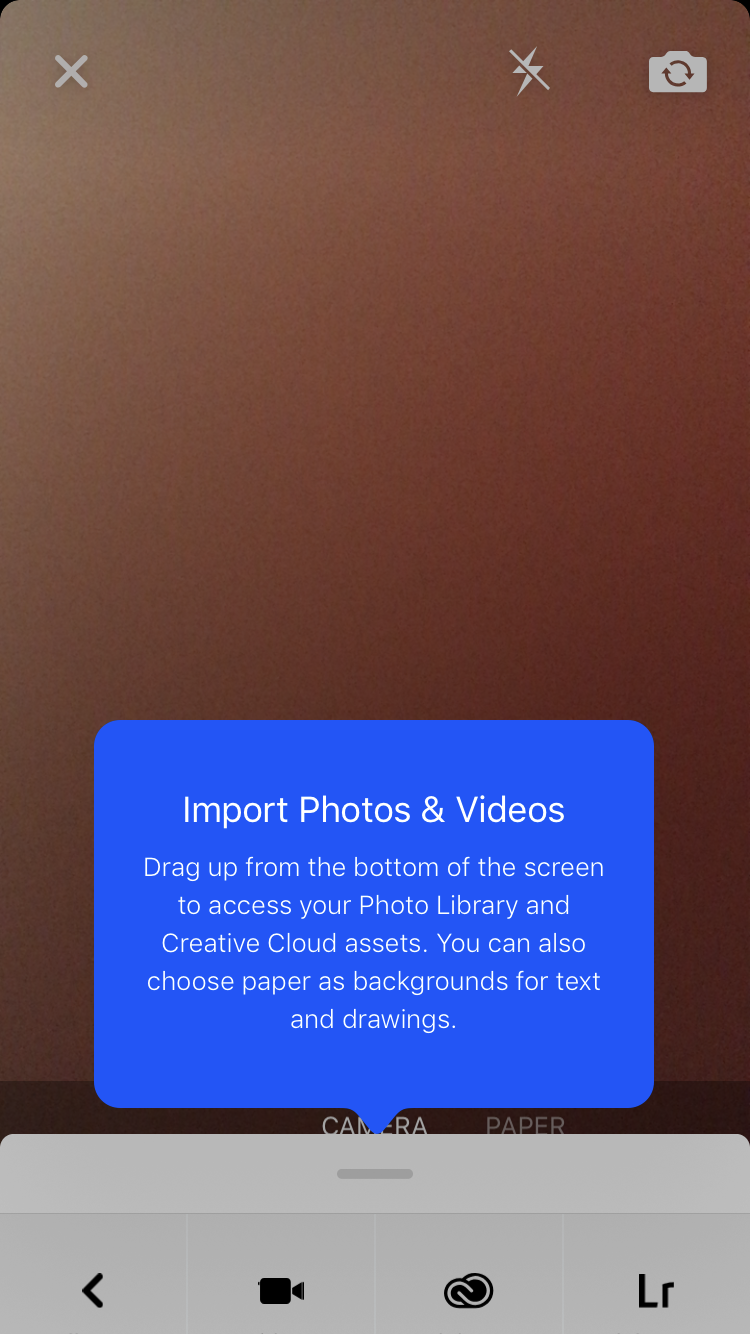 This is a mobile screen shot from Behance mobile app showing a high contrast tooltip against a blurred background. The tootltip title reads "import photos and videos"