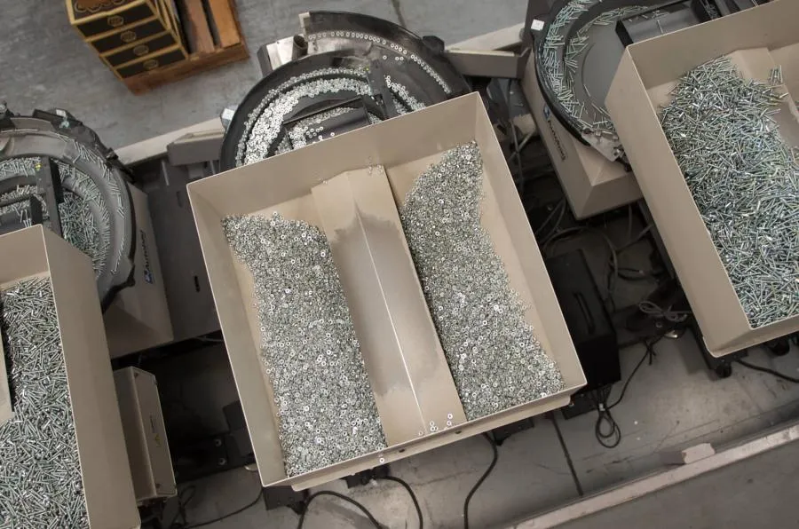 Automated feeder hoppers filled with washers, screws, and other fasteners