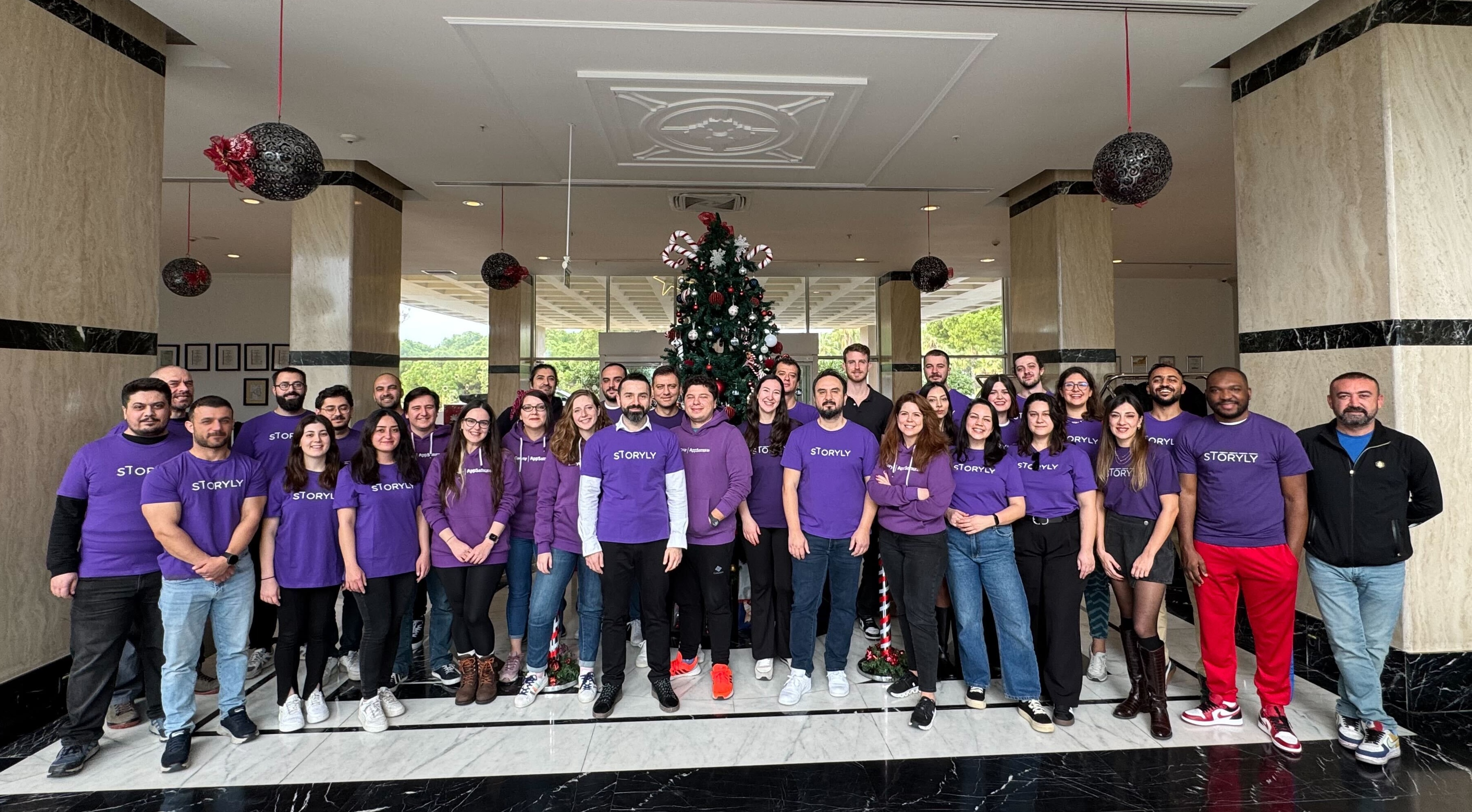 A photo of Storyly's sales, marketing and product team at the physical event wearing their purple Storyly t-shirts.