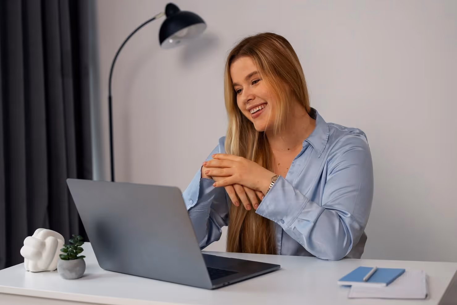 Remote worker smiling while working in her work from home office
