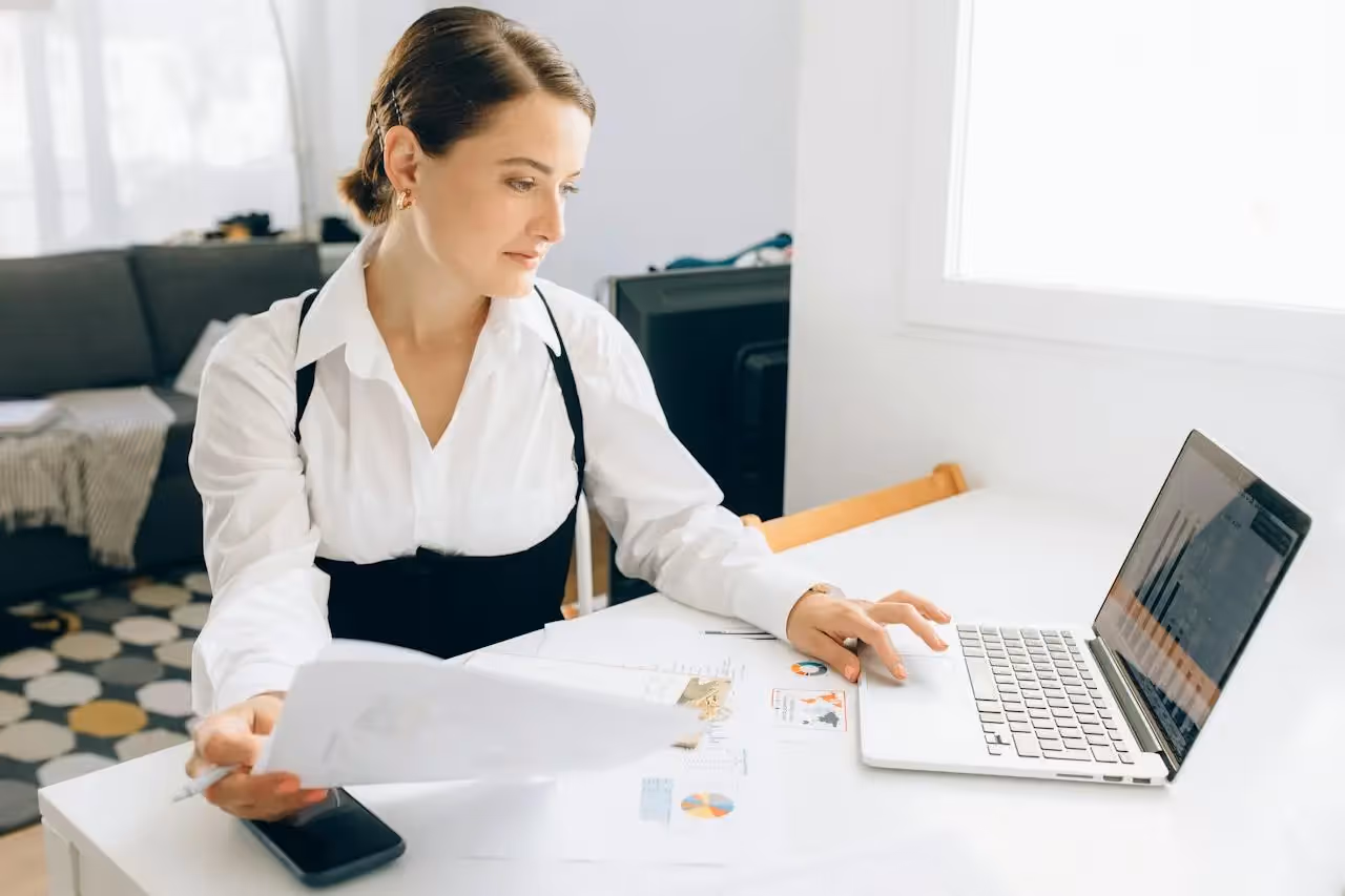 Financial analyst checking reports on her computer