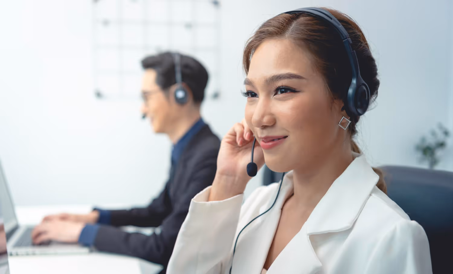 Outsourced worker in office, working while wearing headphone