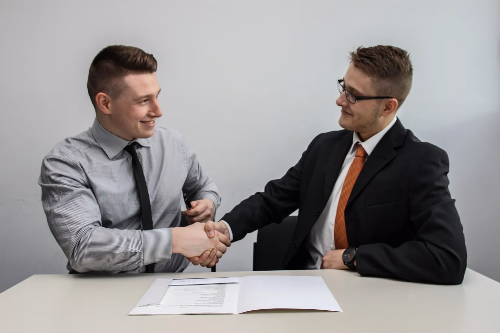 A newly grad young talent shaking hands with hiring manager