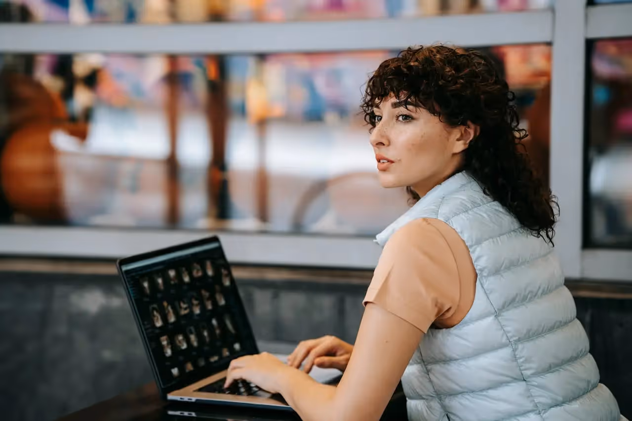 Female remote worker, working outside looking over her shoulder