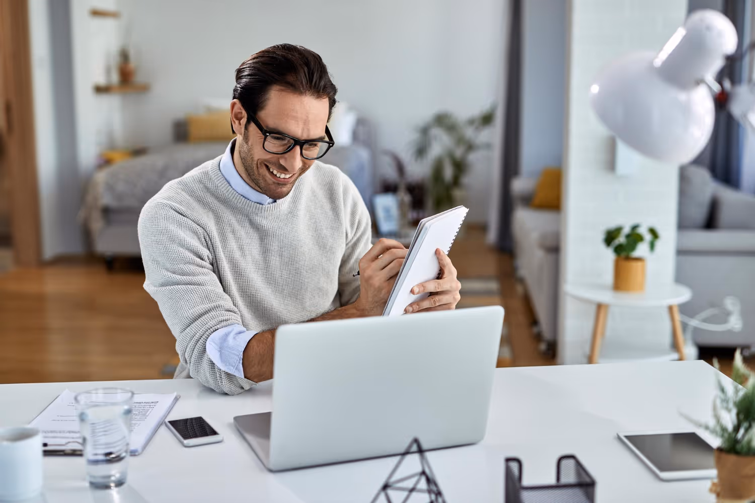 man interviewing remote marketing professionals taking notes