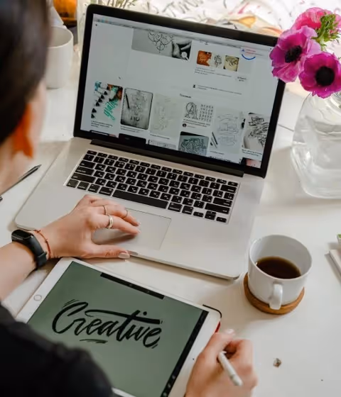 Woman working remotely from her laptop and tablet