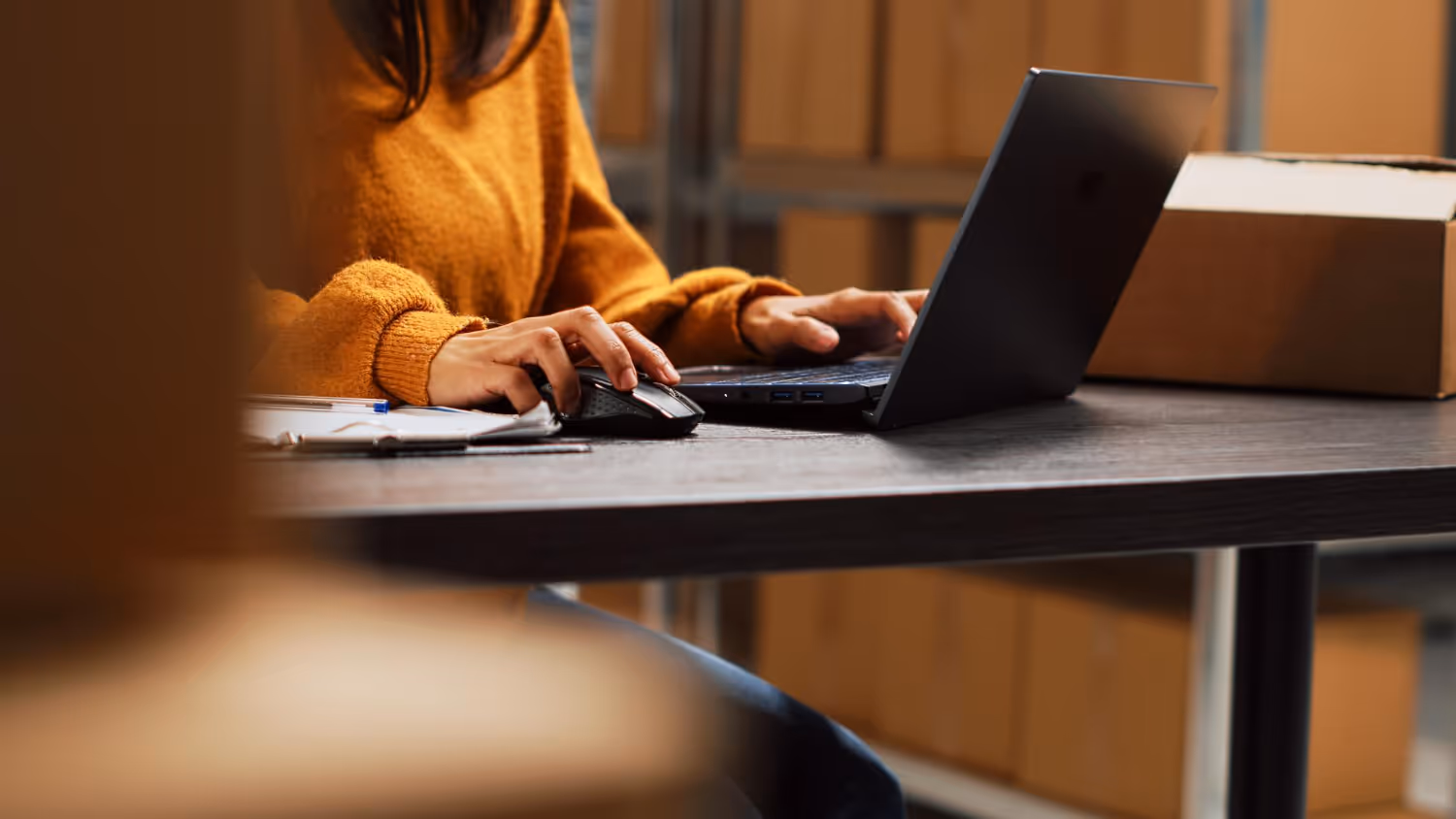 Outsourced logistics specialist working on her laptop