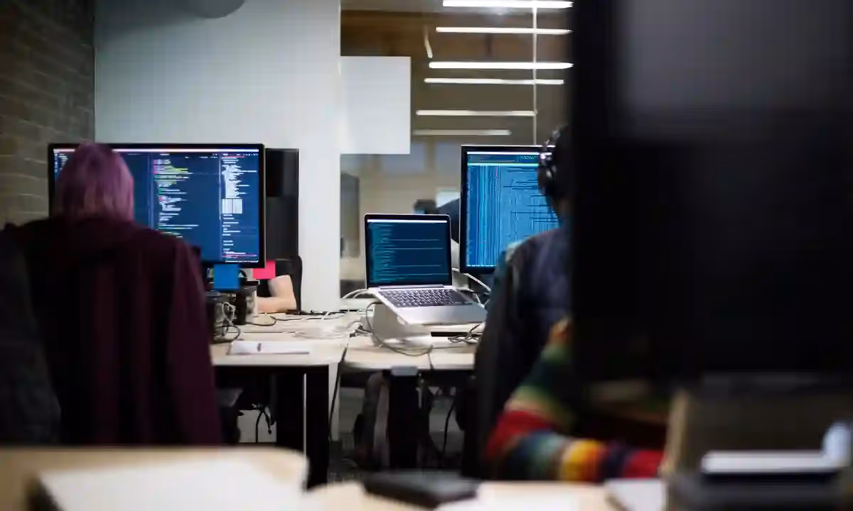 Two people working to hire a developer or outsource