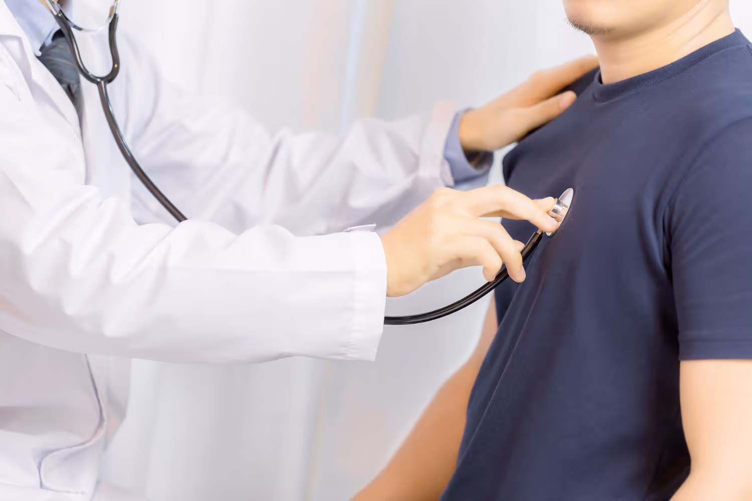 doctor checking patient heartbeat
