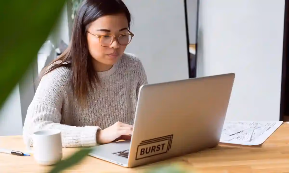 A woman looking on her laptop to see the average outsourced developer salary