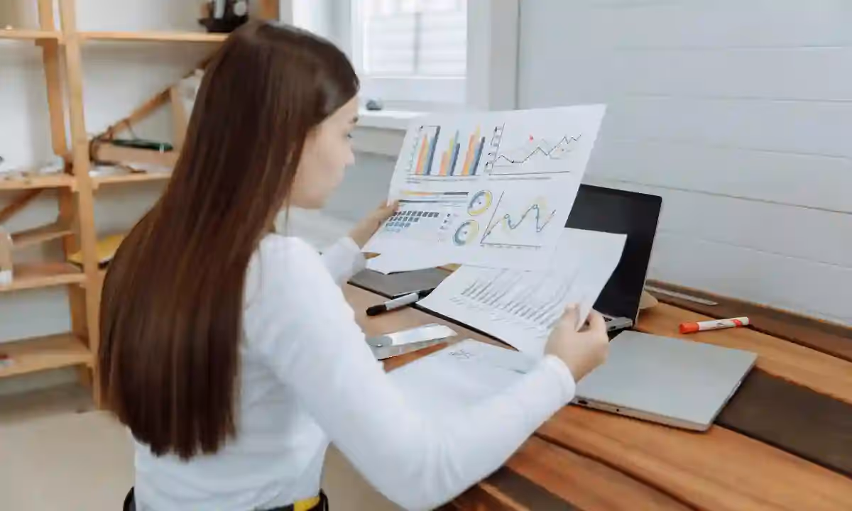 A woman analyzing different data, one of data engineer skills