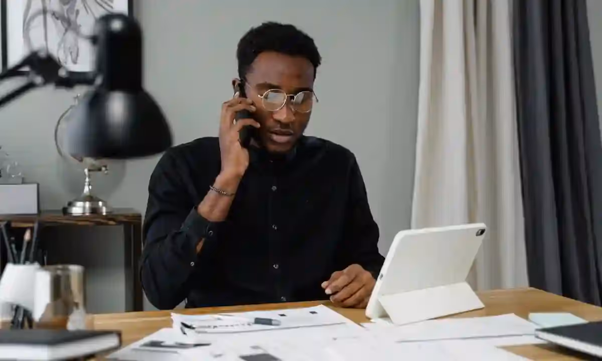 Man talking on the phone from his office.