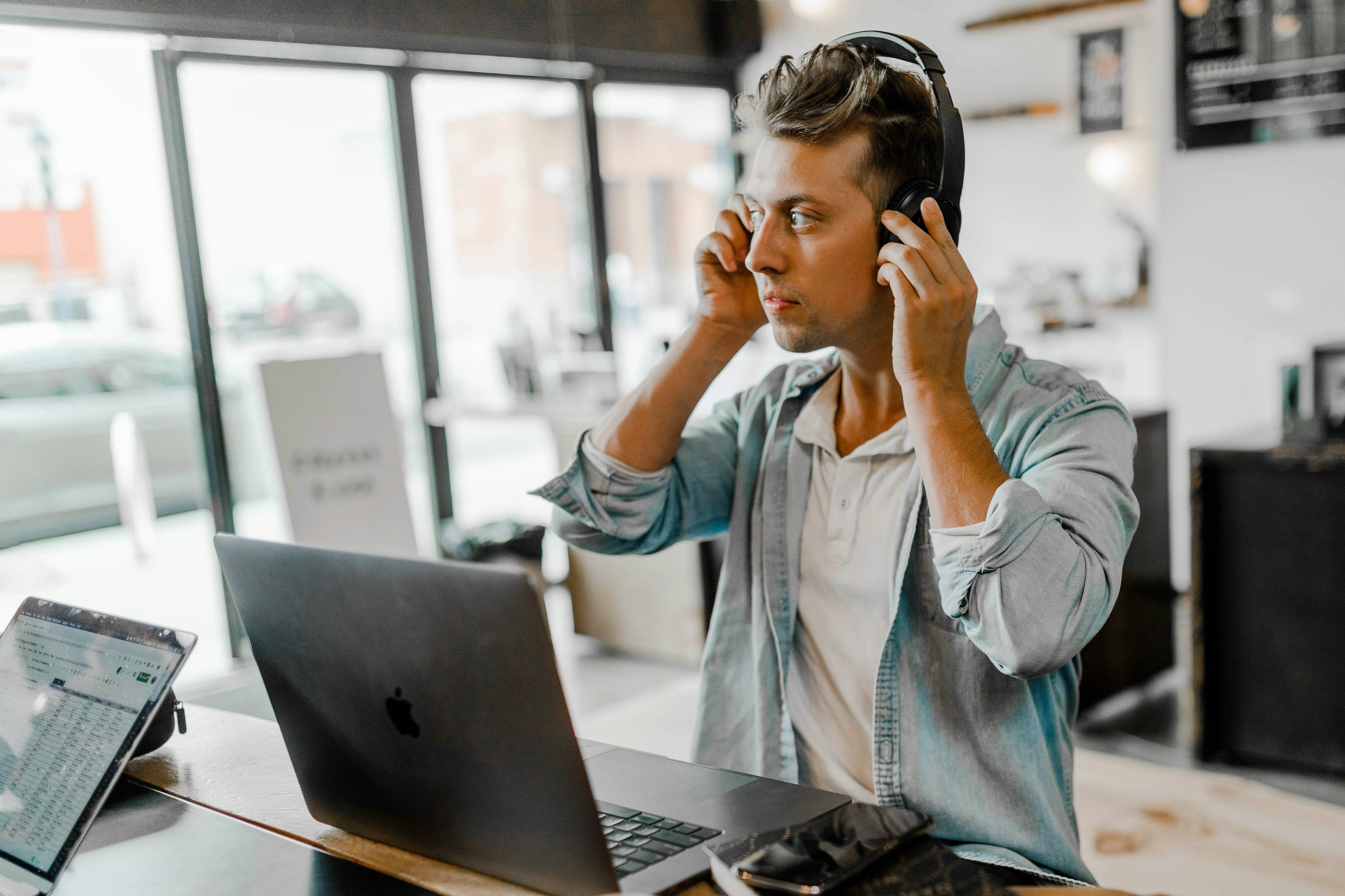 Man with a headset in front of a computer.