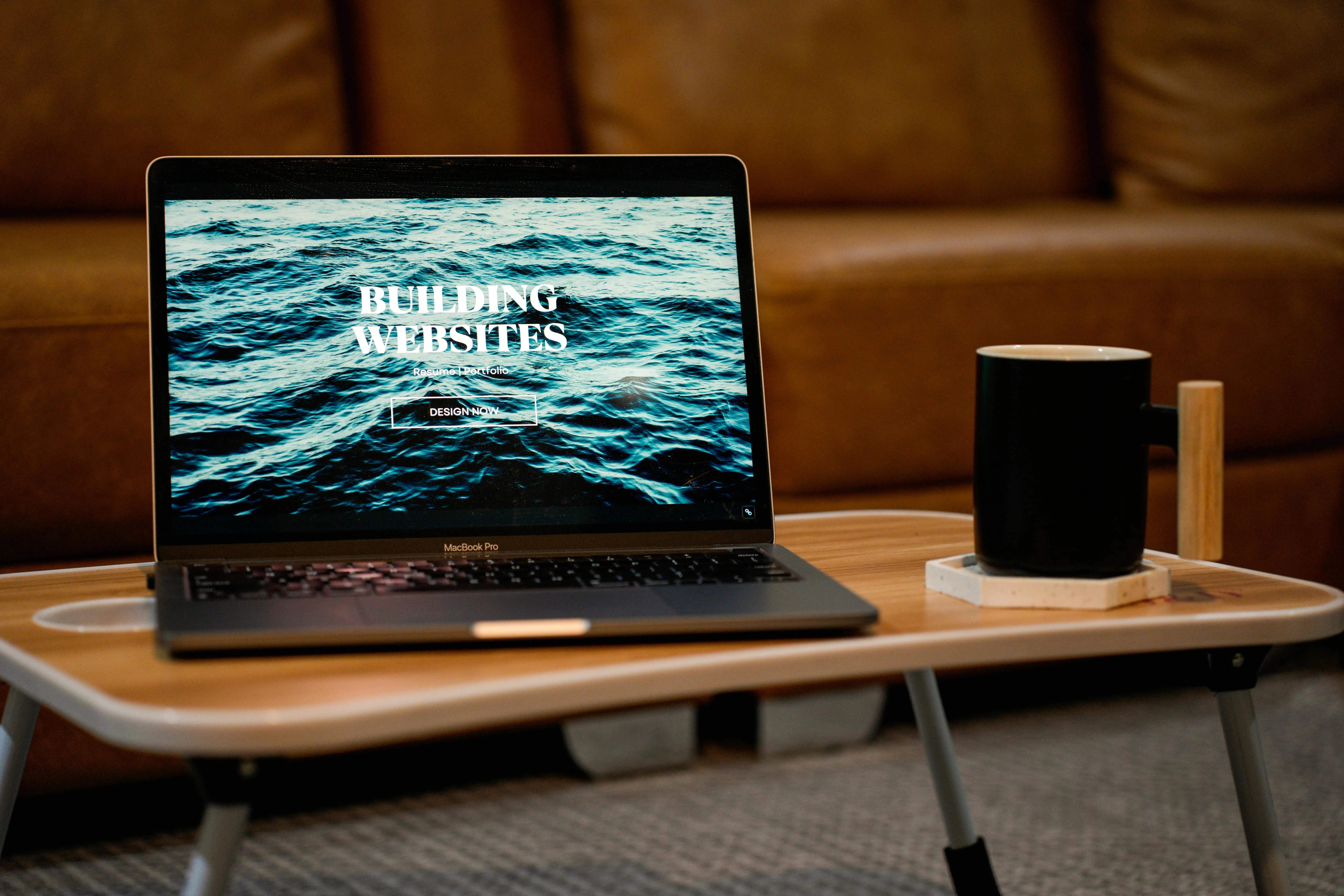 MacBook Pro opened with a Building Websites image on it.