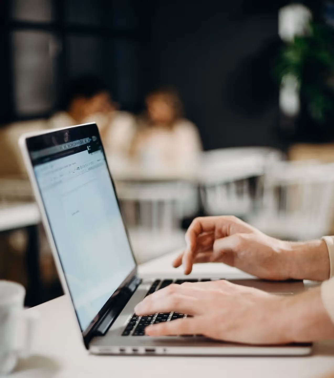 hand typing on laptop