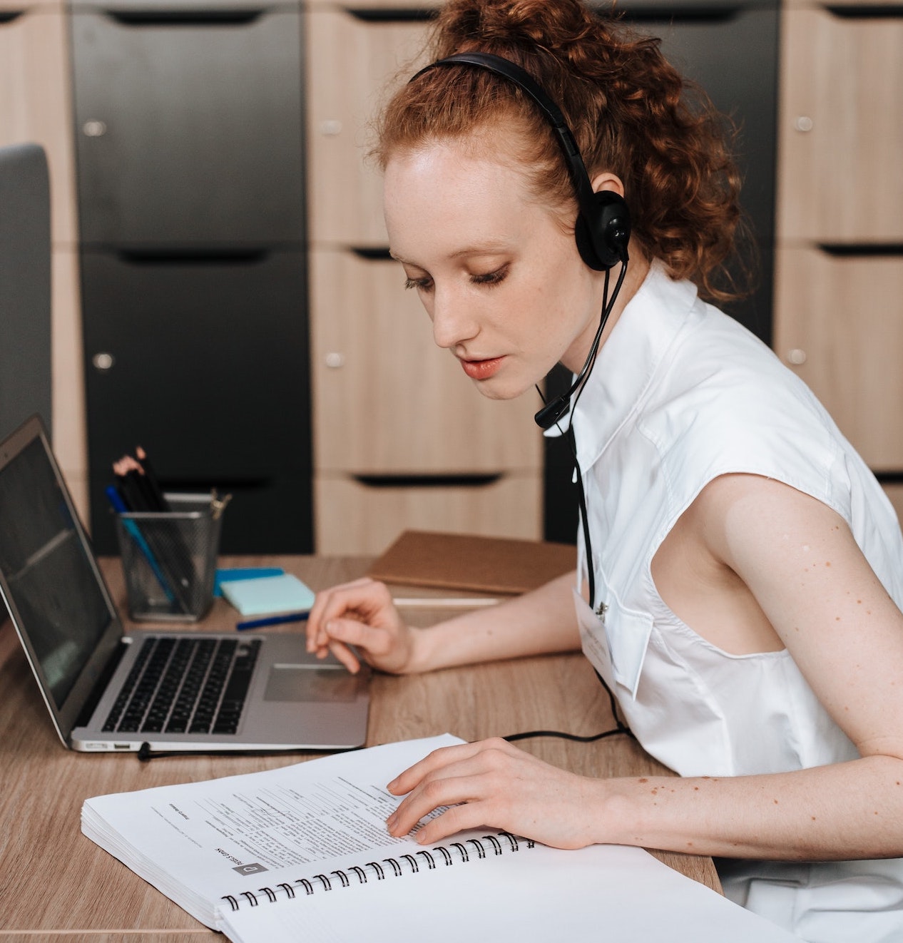woman with headphones reading script