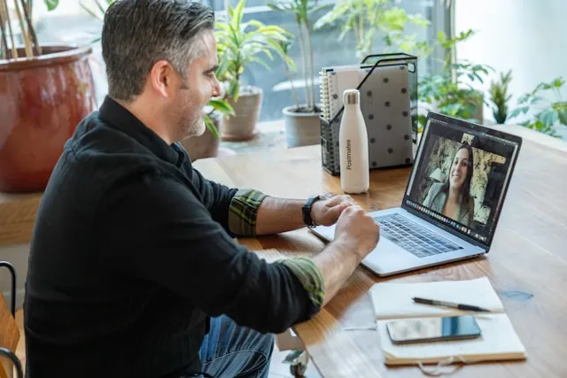 Man having a meeting on his computer from home. 