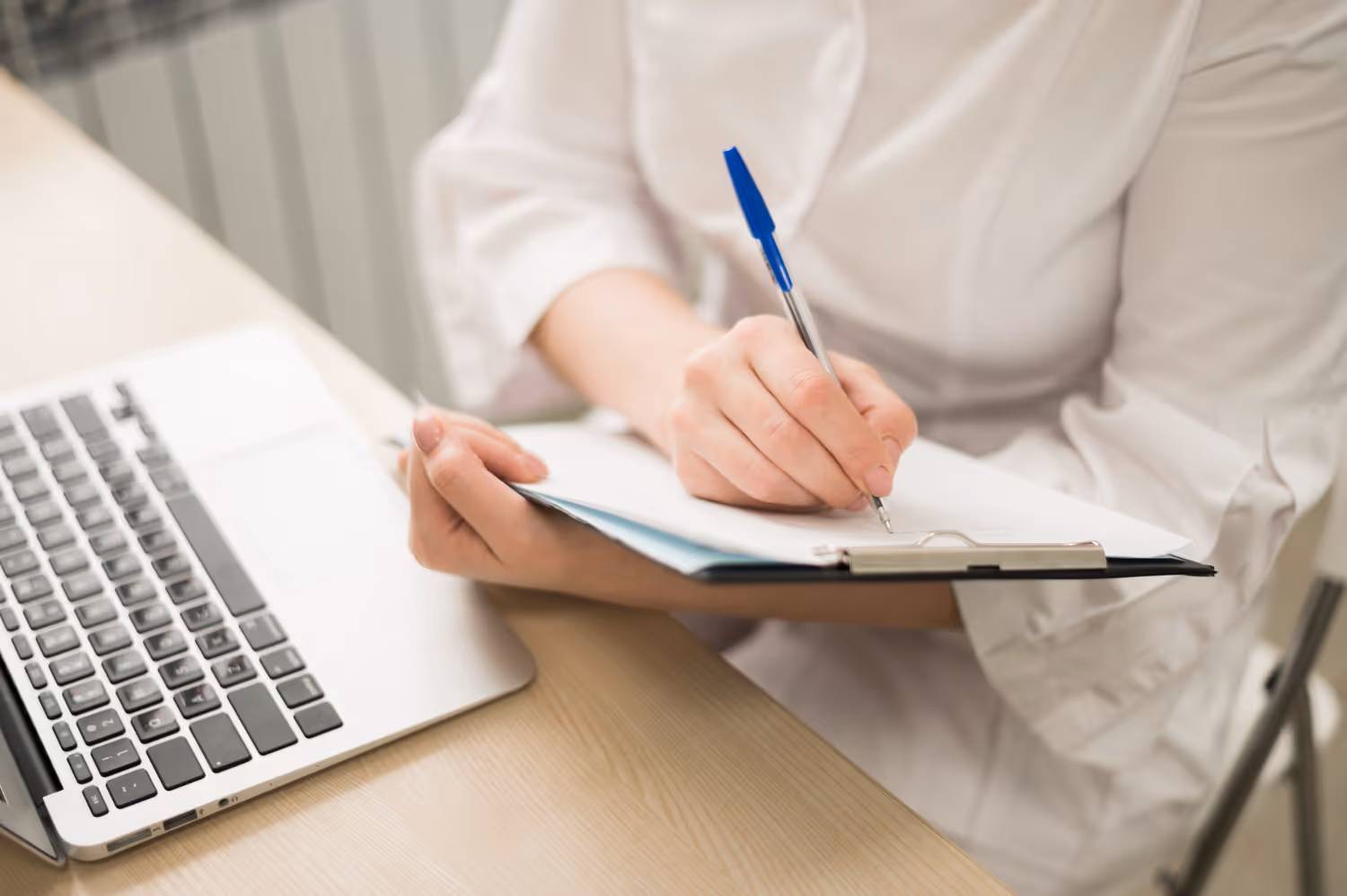 Woman writing down notes on a clipboard