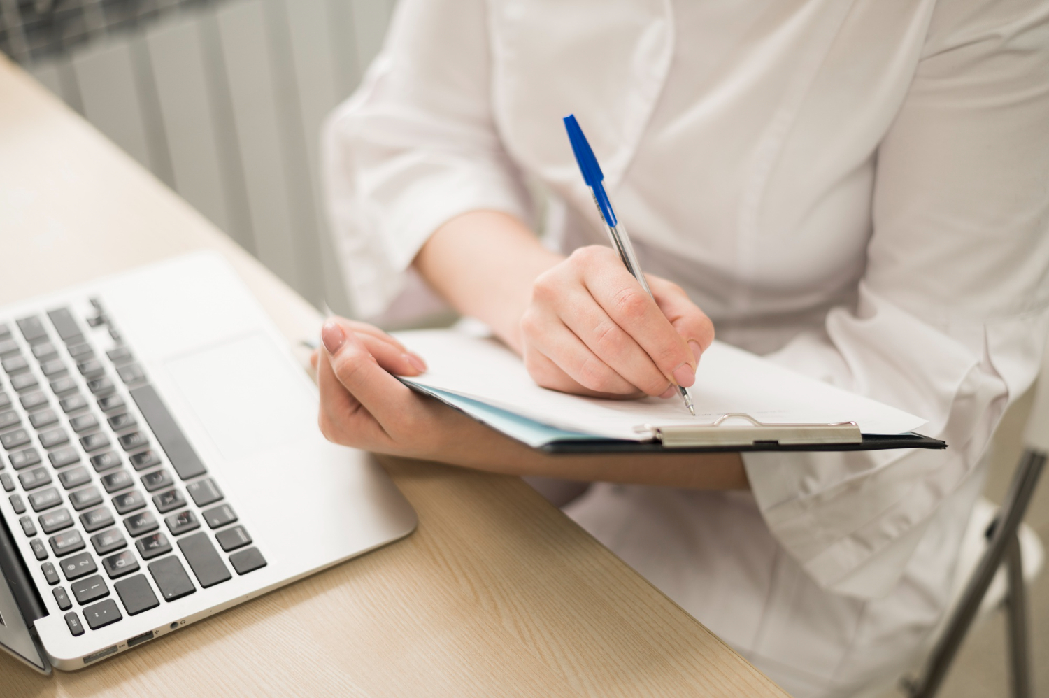 Woman writing down notes on a clipboard