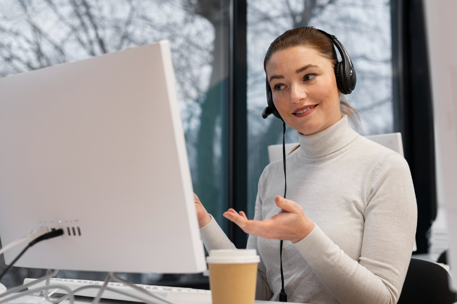 Technical Virtual assistant wearing headphones and on a call with her employer