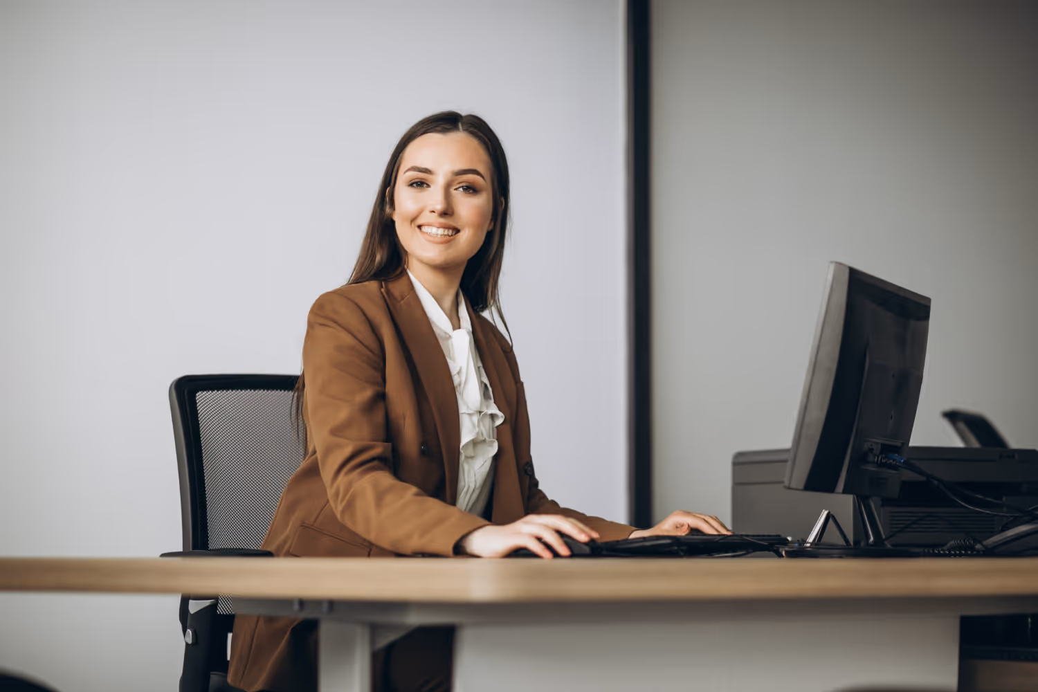 Newly hired bilingual administrative assistant in her workspace