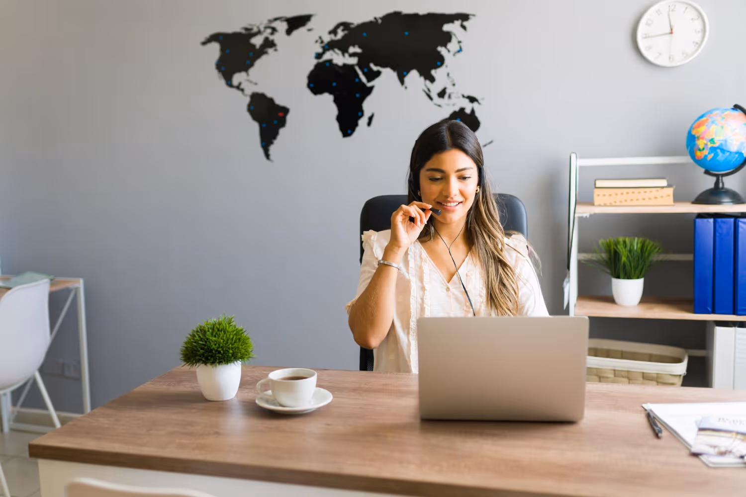 Bilingual Assistant working on her computer wearing headphone