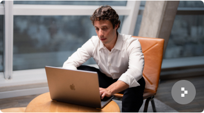 A senior engineer working on a laptop in a bright office, illustrating a fast 24-day time to hire.