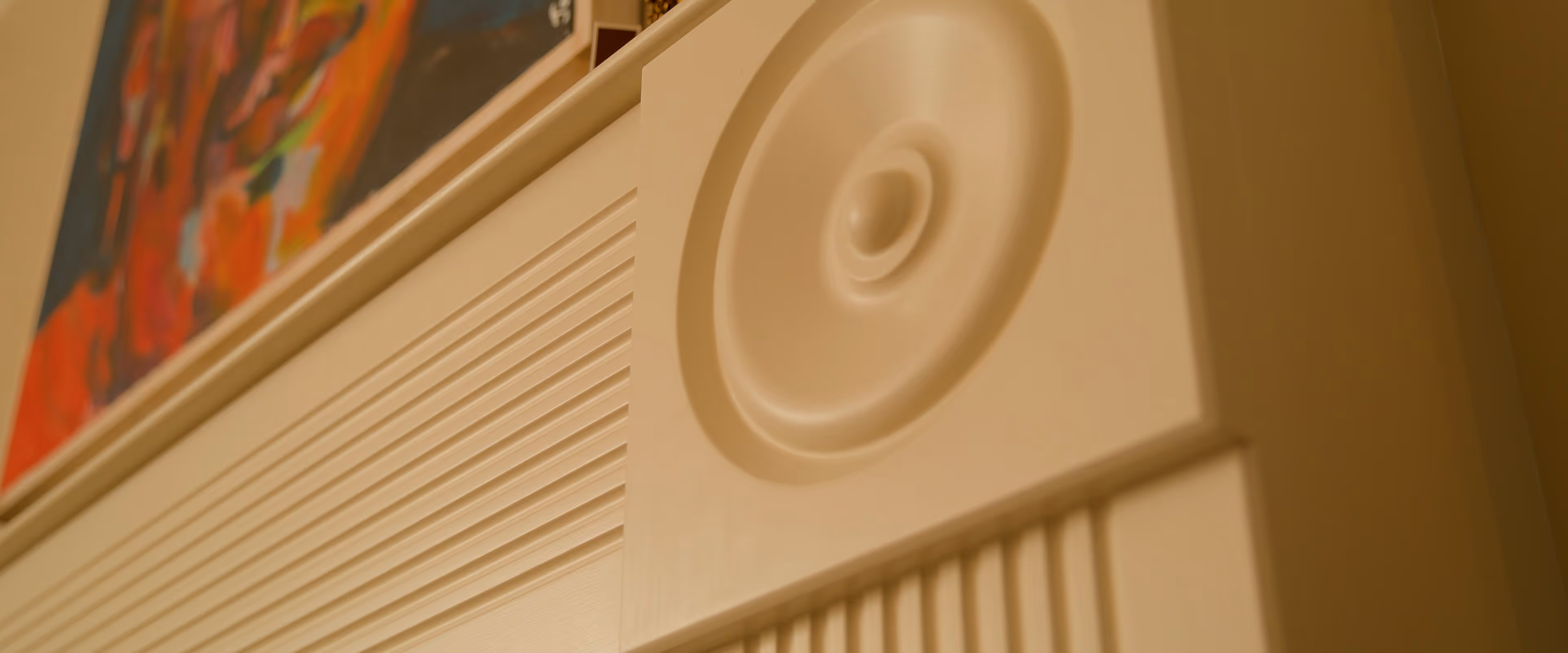 Close-up of a white retro speaker with a circular design and textured surface.