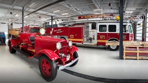 St Mary's Fire Hall interior with old and new trucks