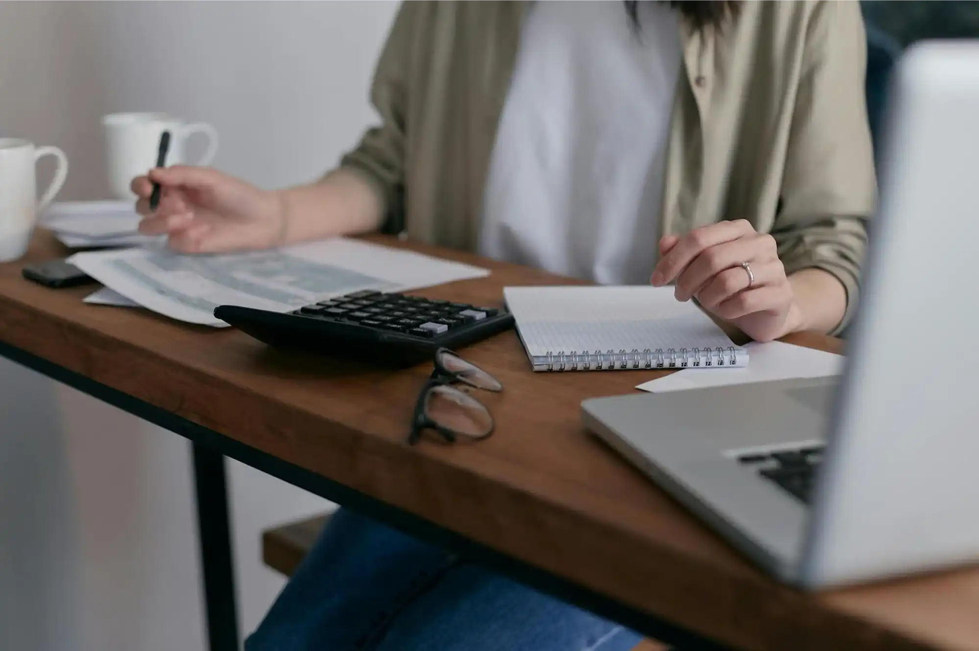 Woman reviewing invoices and cash flow issues at the office desk