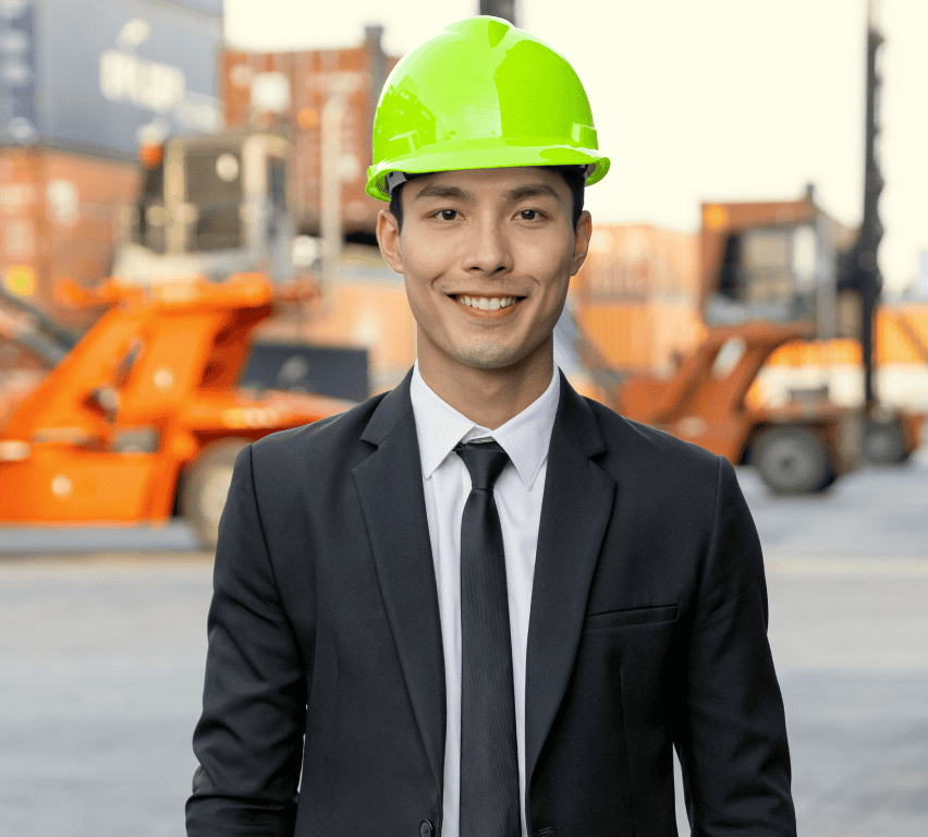 Cross-dock facility manager in suit and hi-vis hard hat at a container terminal, coordinating dock-to-dock flow with Goramp