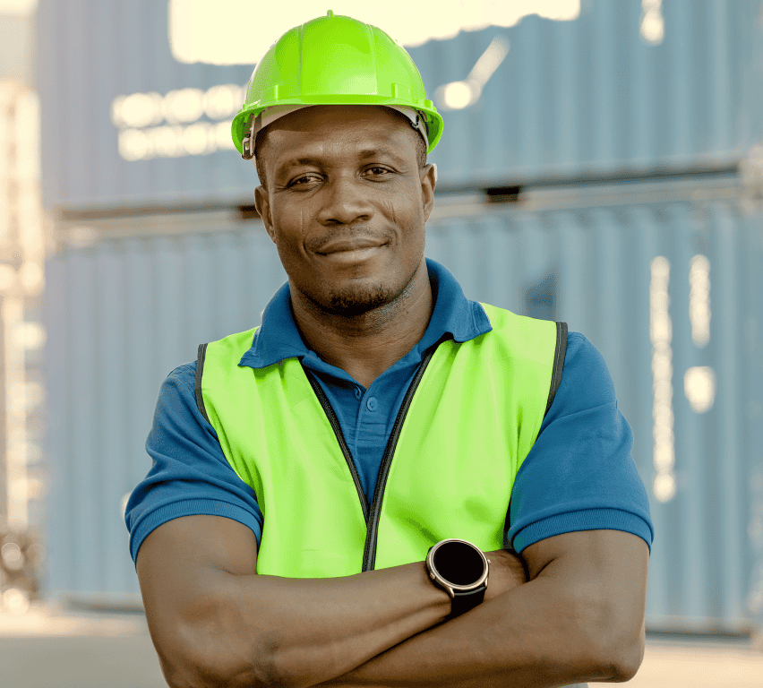 Cross-dock worker in hi-vis vest and hard hat at the container yard, coordinating dock transfers with Goramp