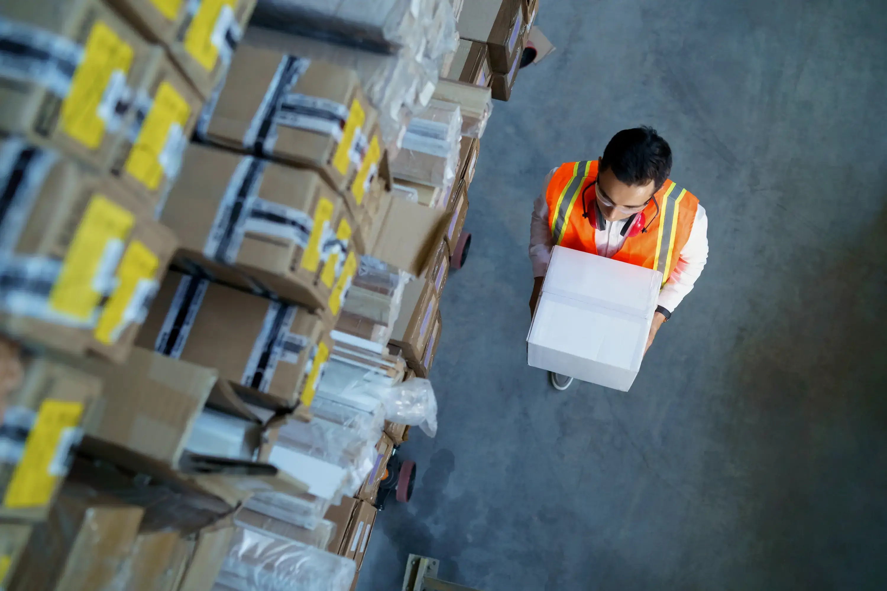 logistics warehouse worker with box in his hands