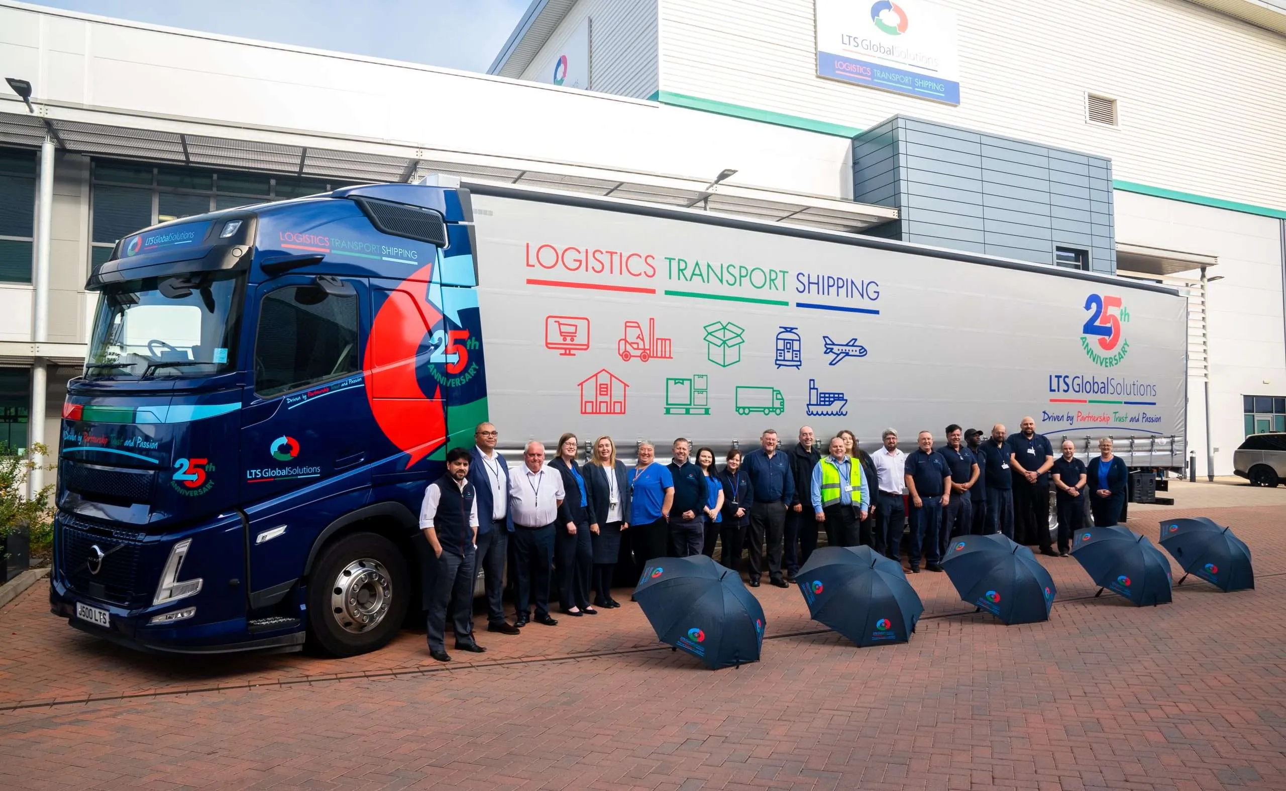 Global Logistics Solutions' truck and employees standing in front of it. 