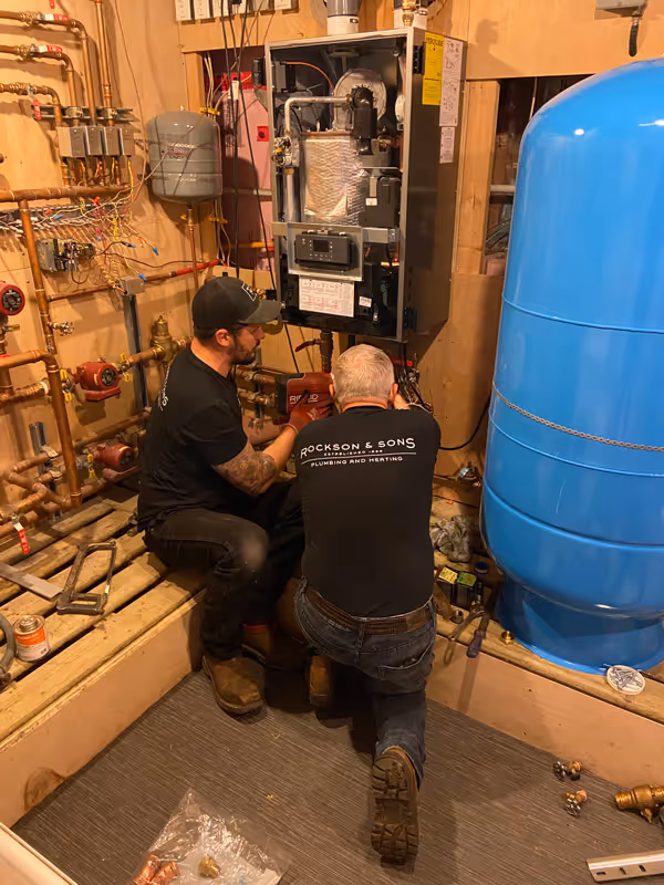 Rockson and sons working on an indoor heating system. 