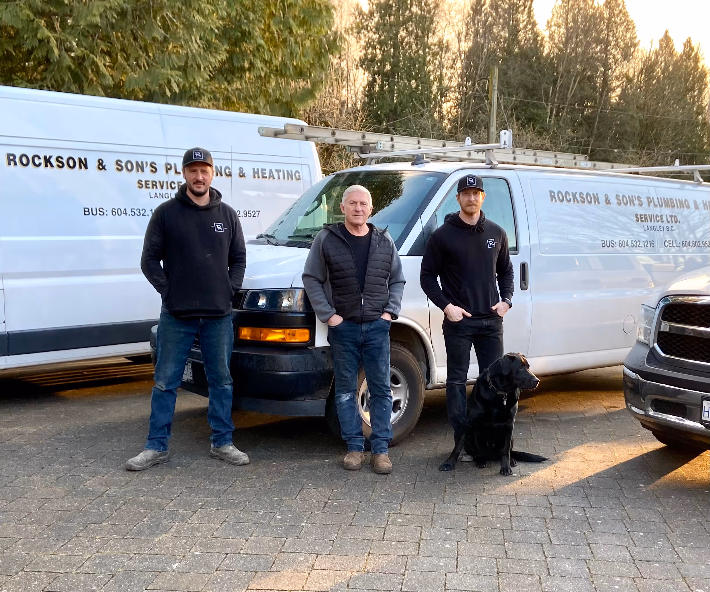 Rockson & sons in front of service vans.