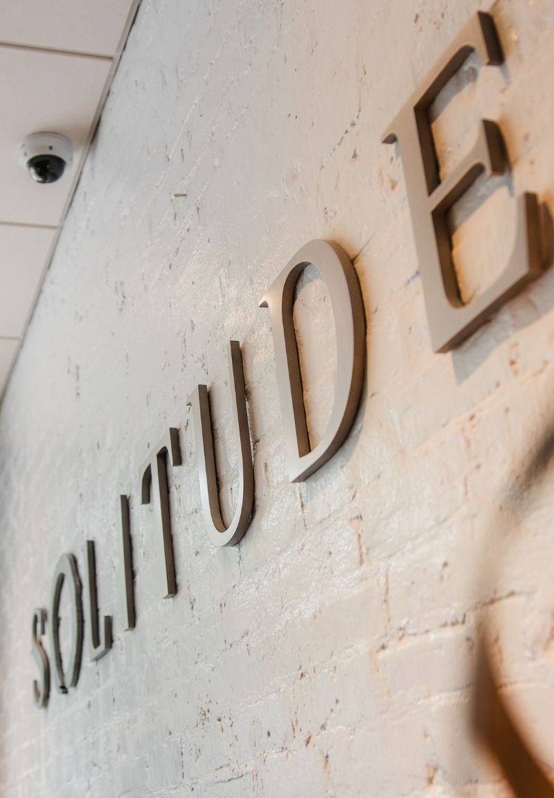 Solitude letters on brick wall