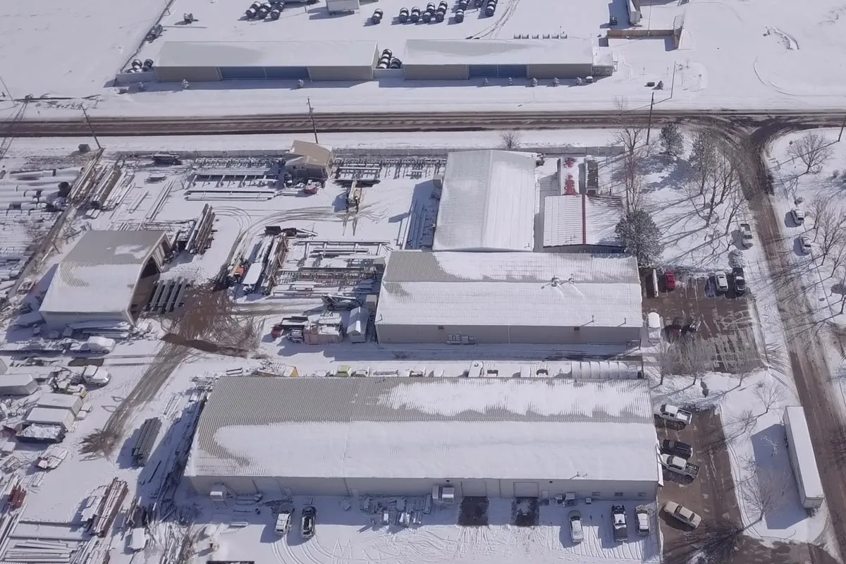 aerial view of shop with snow on roof