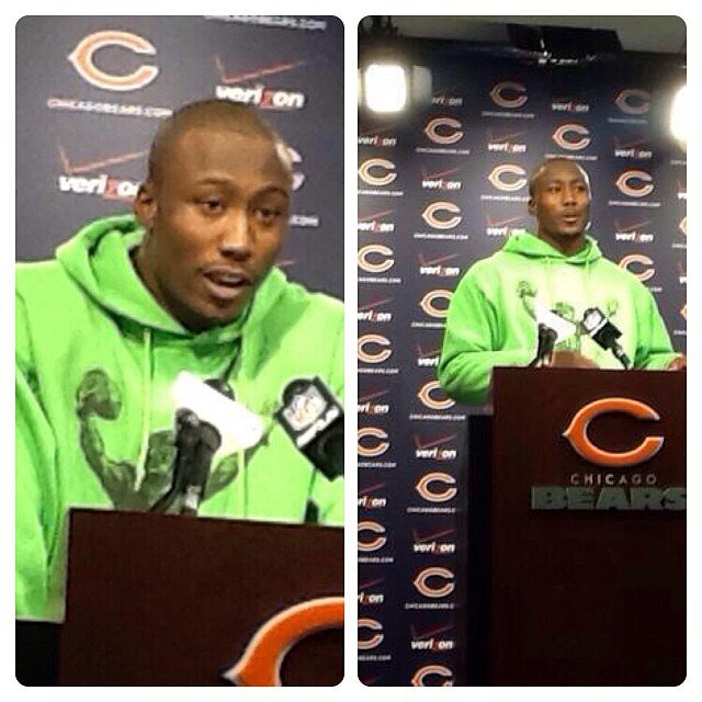 Chicago Bears player at a press conference in a green hoodie