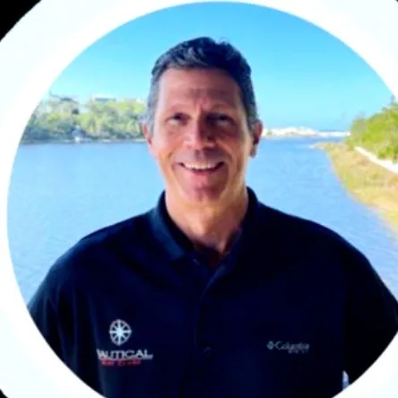 Tom Gardiner, Nautical Boat Club, in a branded polo by the water