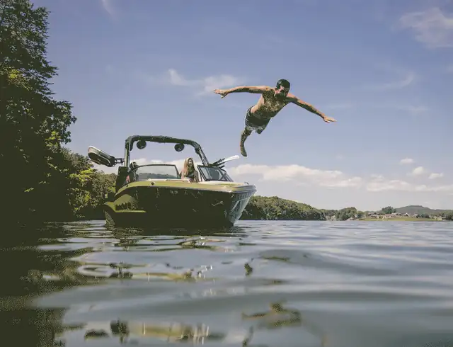 Man diving off a wakeboat on the lake, Nautical Boat Club Boat Life Without Limits animation