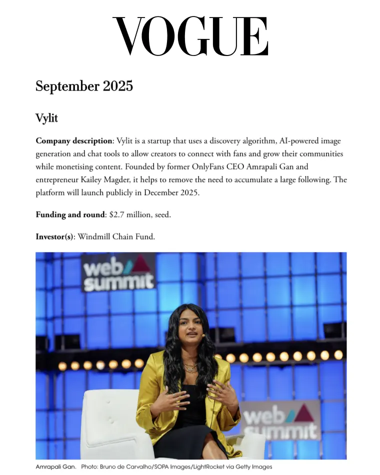 Amrapali Gan speaking on stage at Web Summit, wearing a yellow blazer and black dress.