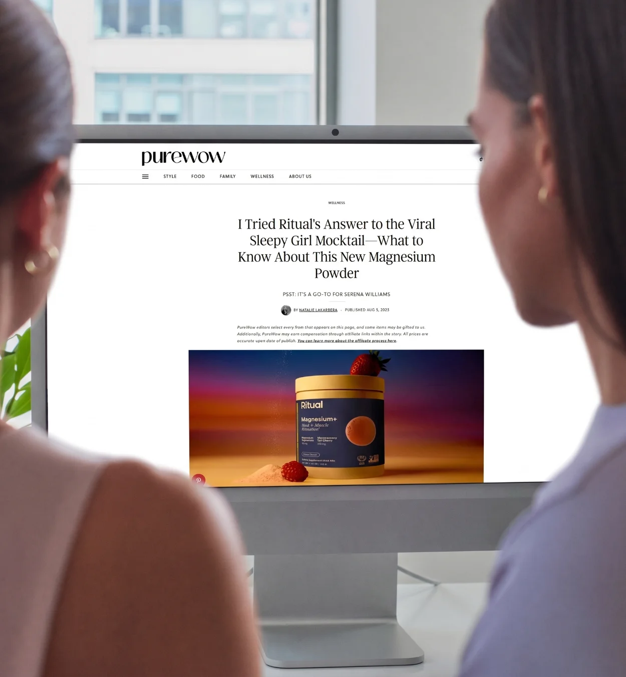 Two people view a computer screen showing a PureWow article about Ritual's magnesium powder.