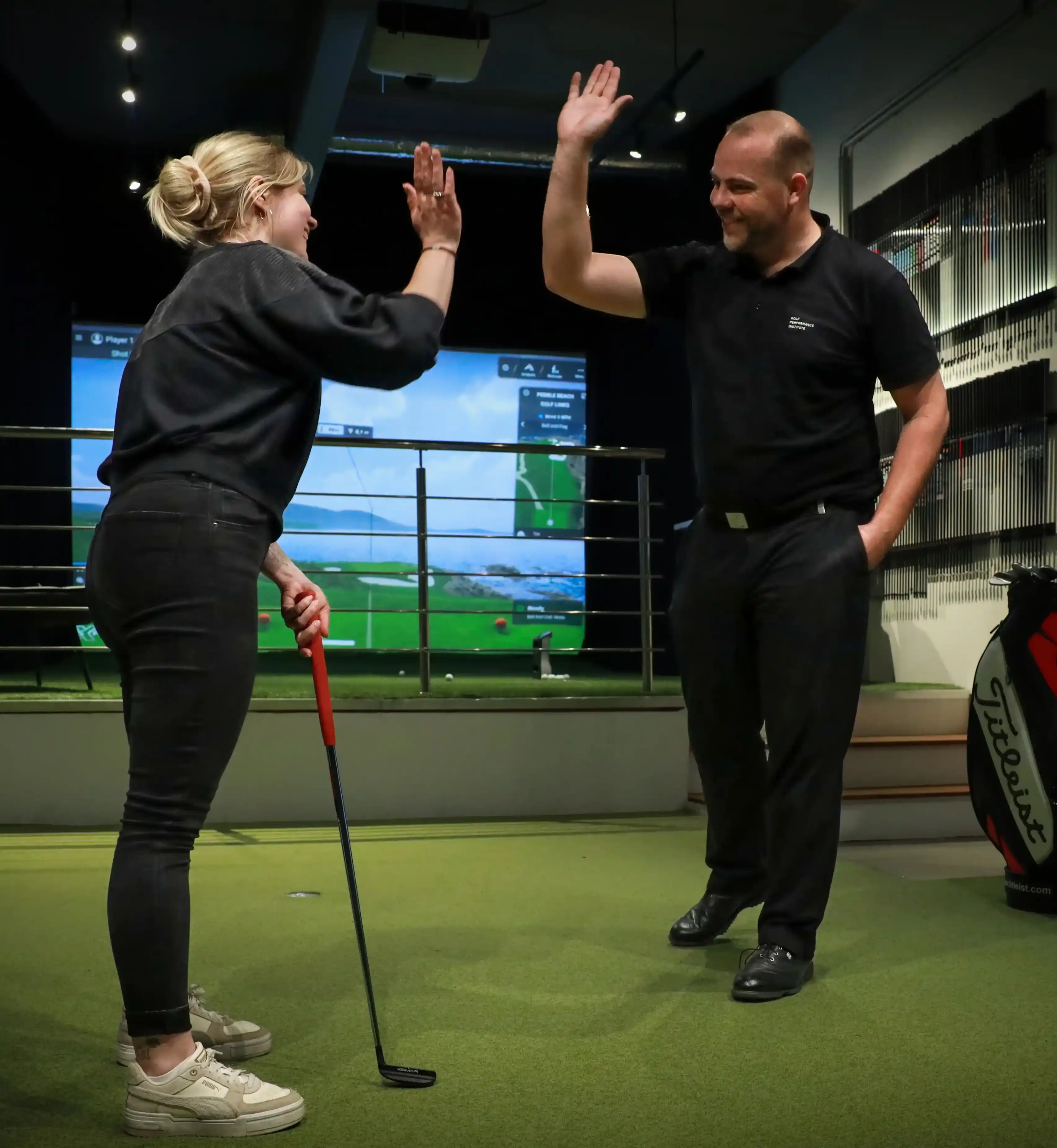 Golf coach working at the simulator